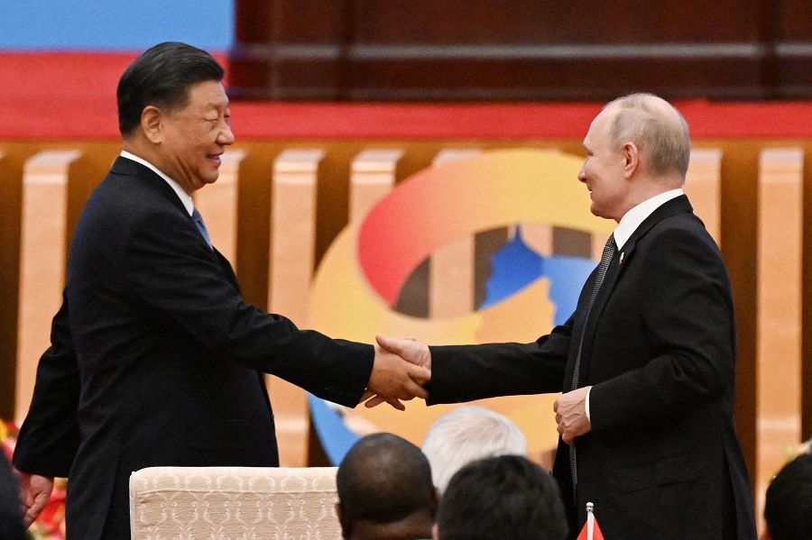 Chinese President Xi Jinping shakes hands with Russian President Vladimir Putin during the opening ceremony of the third Belt and Road Forum in Beijing, China, on 18 October 2023. (Pedro Pardo/AFP)