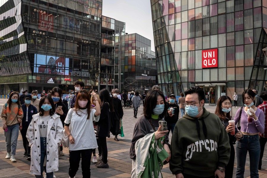 People at a shopping mall in Beijing, April 19, 2020. China's economy shrank for the first time in decades last quarter. (Nicolas Asfouri/AFP)