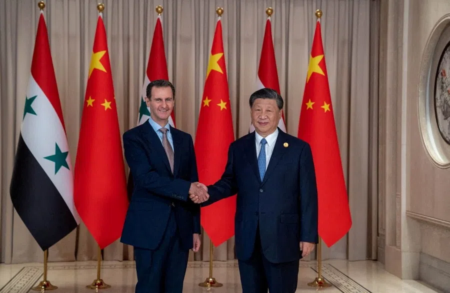 Chinese President Xi Jinping shakes hands with then Syrian President Bashar al-Assad in eastern Hangzhou city, in this handout picture released by SANA on 22 September 2023. (SANA via Reuters)