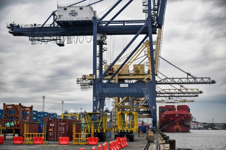 Workers load and unload containers at the Tanjung Priok International Export-Import Port in Jakarta on 4 February 2026. (Bay Ismoyo/AFP)