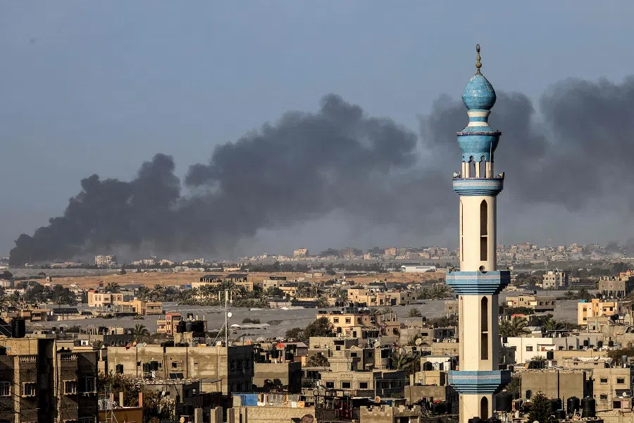 A picture taken from Rafah shows smoke billowing over Khan Yunis in the southern Gaza Strip during Israeli bombardment on 22 January 2024, amid ongoing battles between Israel and the Palestinian militant group Hamas. (AFP)