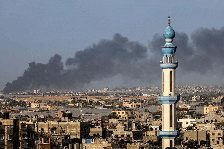 A picture taken from Rafah shows smoke billowing over Khan Yunis in the southern Gaza Strip during Israeli bombardment on 22 January 2024, amid ongoing battles between Israel and the Palestinian militant group Hamas. (AFP)