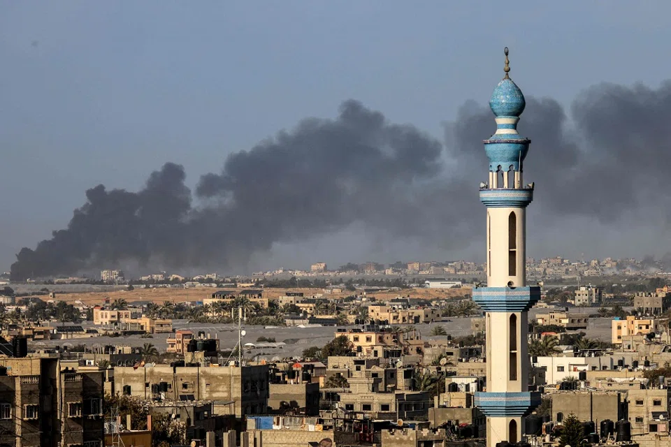 A picture taken from Rafah shows smoke billowing over Khan Yunis in the southern Gaza Strip during Israeli bombardment on 22 January 2024, amid ongoing battles between Israel and the Palestinian militant group Hamas. (AFP)