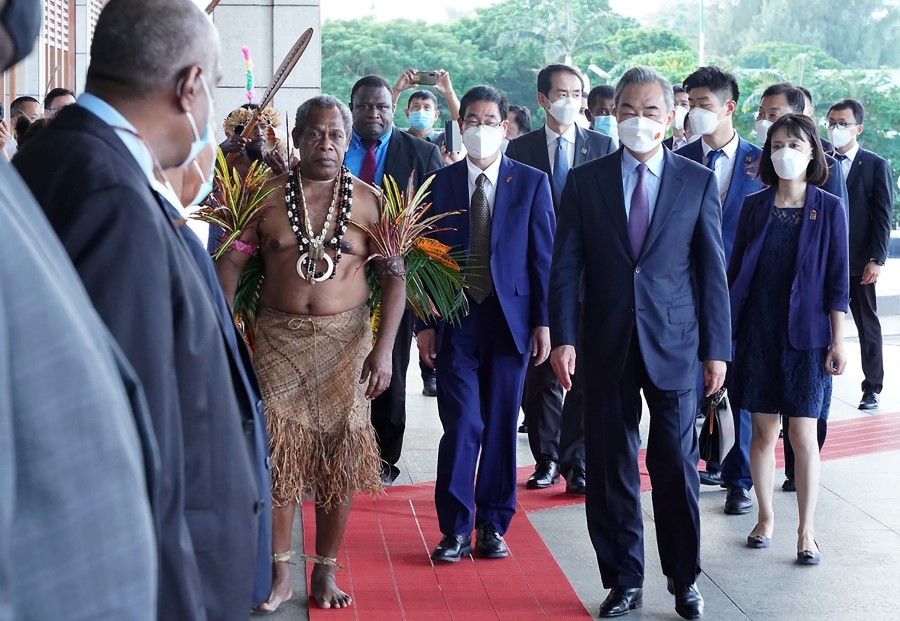 Chinese Foreign Minister Wang Yi (right) arrives at the convention centre with Chief of Malvatumauri National Council Willie Plasua (second from left) after a meeting with the Vanuatu President Tallis Obed Moses in Vanuatu capital city of Port Vila on 1 June 2022. (Ginny Stein/AFP)