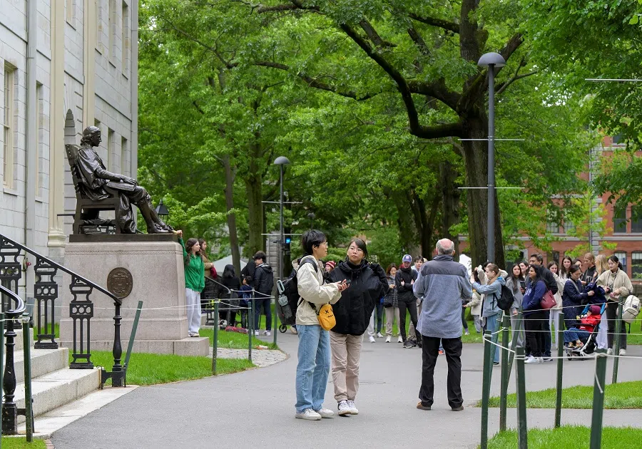 People walk on the campus of Harvard University in Cambridge, Massachusetts, US, on 23 May 2025. (Faith Ninivaggi/Reuters)