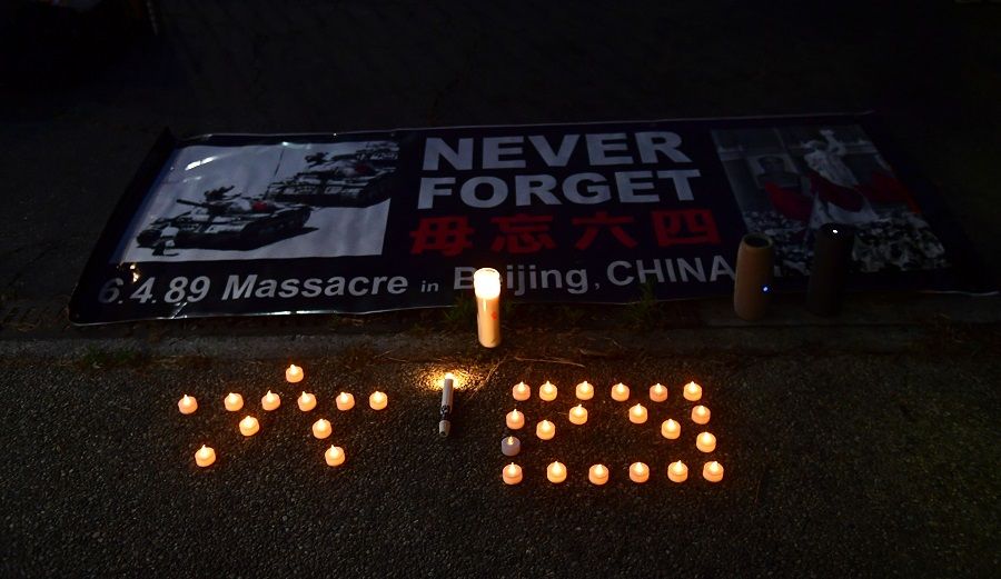 Candles are placed in the Chinese characters for "6" and "4" during a vigil across the road from the Chinese consulate in Los Angeles, California on 4 June 2020, where activists gathered to commemorate the 31st anniversary of the 1989 June 4 Tiananmen Square protests in Beijing, China. (Frederic J. Brown/AFP)