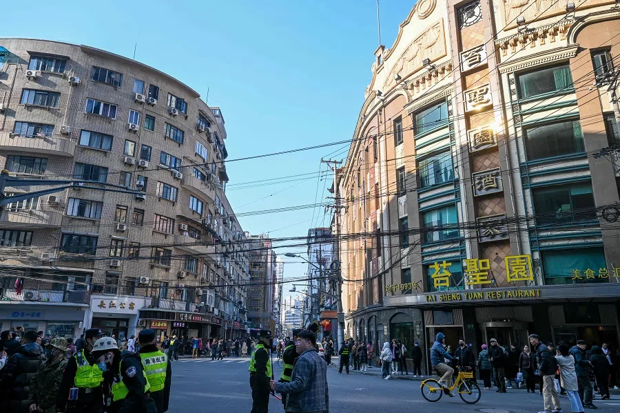 The photo taken on 7 January 2024 shows people visiting Huanghe Road, a historic location that features in the Chinese television series Blossoms Shanghai directed by Hong Kong director Wong Kar-wai, in Shanghai. (AFP)