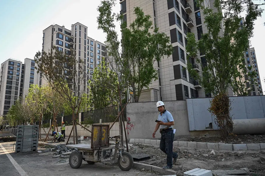 Workers are seen at a housing complex under construction in Beijing on 17 May 2024. (Jade Gao/AFP)