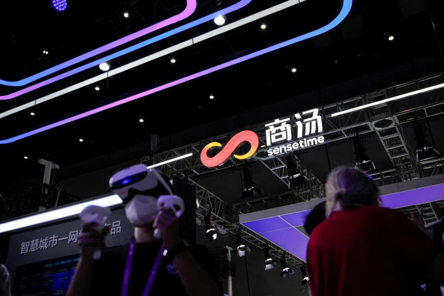 People stand in front of a sign of SenseTime during World Artificial Intelligence Conference, following the Covid-19 outbreak, in Shanghai, China, 1 September 2022. (Aly Song/Reuters)