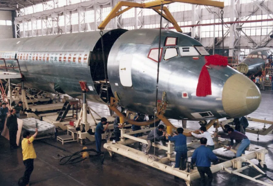 An MD-82 aircraft being assembled at the Shanghai Aircraft Manufacturing Plant, 1999. China worked with US company McDonnell Douglas to produce passenger aircraft, with the ultimate goal of achieving self-sufficiency.