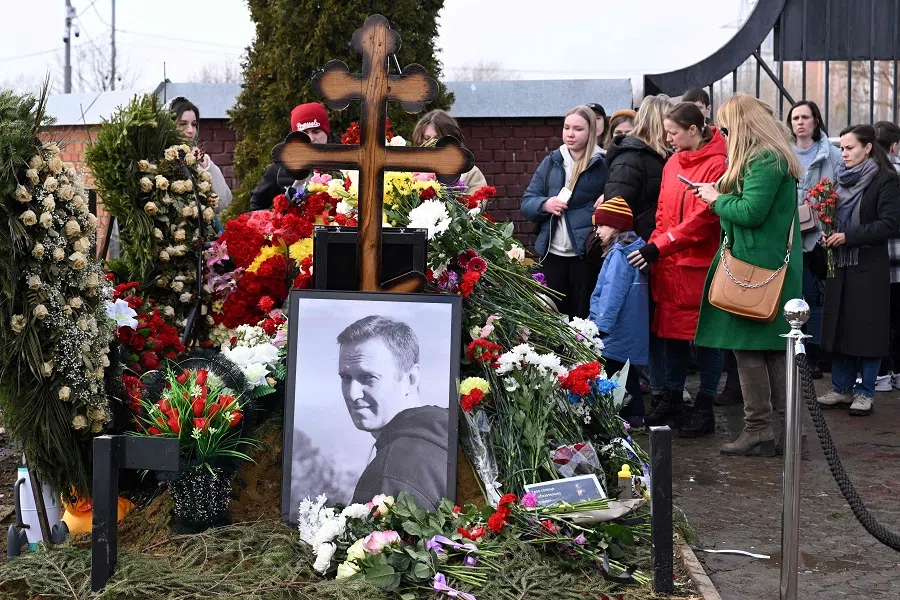People pay tribute at the grave of late Russian opposition leader Alexei Navalny on the day of Russia's presidential election in Moscow on 17 March 2024. (Natalia Kolesnikova/AFP)