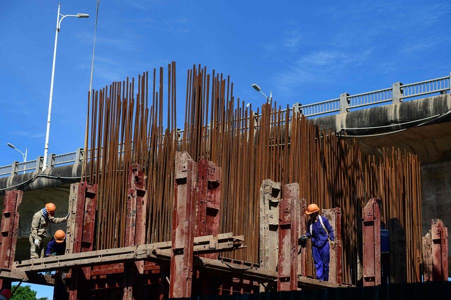Workers work on a bridge construction project in Hanoi, Vietnam on 15 June 2021. (Nhac Nguyen/AFP)