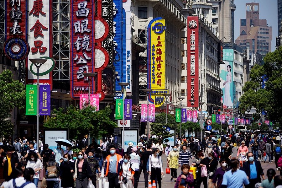 People walk along Nanjing Road, a main shopping area in Shanghai, China on 5 May 2021. (Aly Song/File Photo/Reuters)