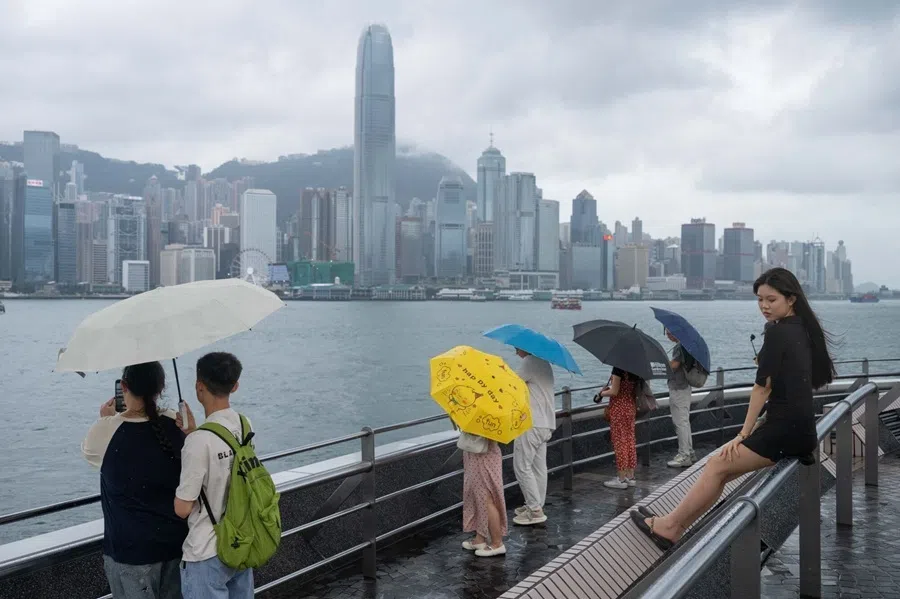 Visitors carrying umbrellas at the Tsim Sha Tsui promenade in Hong Kong, China, on 30 July 2026.