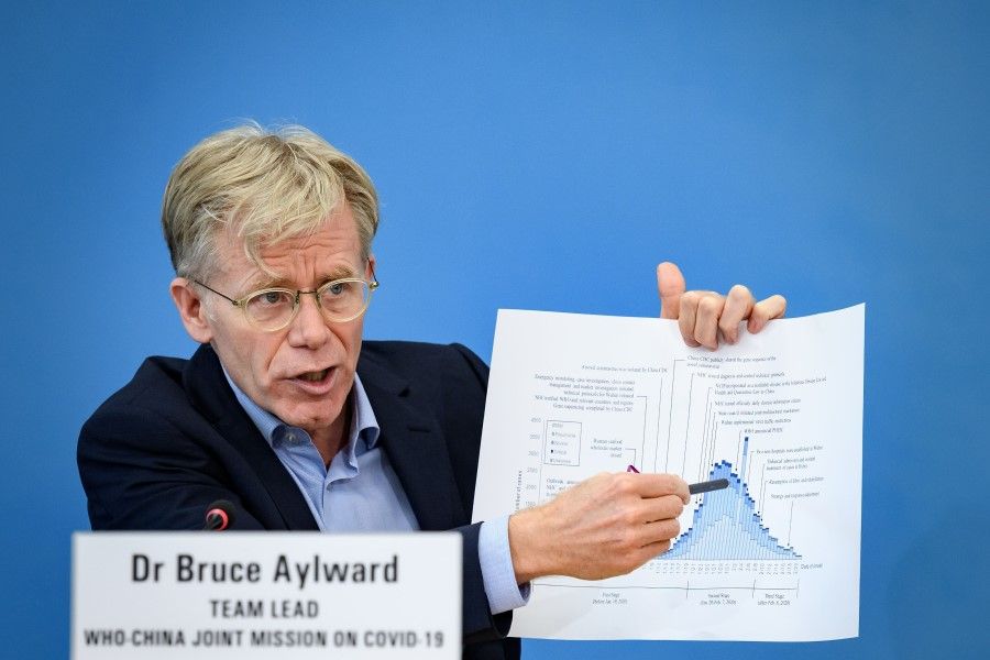 Team leader of the joint mission between World Health Organization (WHO) and China on Covid-19, Bruce Aylward shows graphics during a press conference at the WHO headquarters in Geneva on February 25, 2020. (Fabrice Coffrini/AFP)