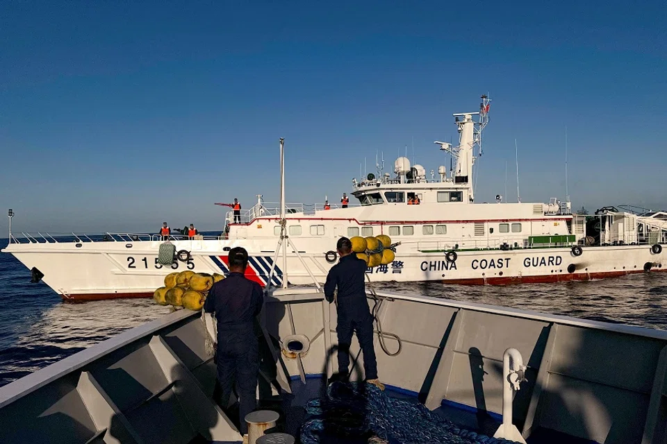 Philippine Coast Guard personnel prepare rubber fenders after Chinese Coast Guard vessels blocked their way to a resupply mission at the Second Thomas Shoal in the South China Sea, on 5 March 2024. (Adrian Portugal/Reuters)