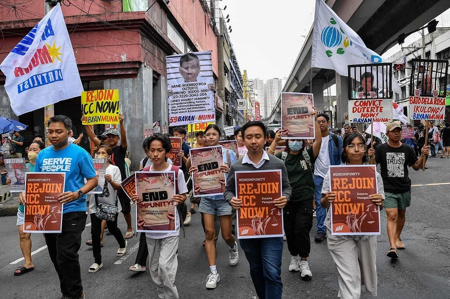Protesters carrying placards showing former president Rodrigo Duterte (left) and Senator Ronald dela Rosa (right) in a prison cell take part in a rally near Malacanang palace in Manila on 17 March 2025. (Ted Aljibe/AFP)