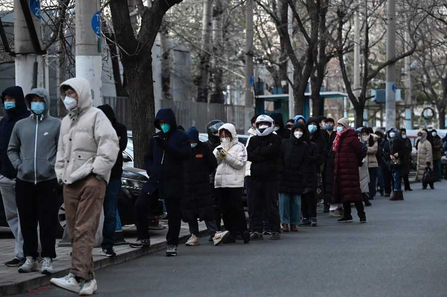 People wait in a long queue to be tested for Covid-19 at an open nucleic acid testing site as many testing stations are shut down in Beijing on 3 December 2022. (Jade Gao/AFP)