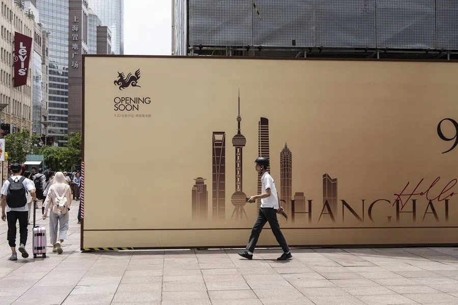 Pedestrians walk past a shop under renovation on Nanjing Road in Shanghai, China, on 27 July 2024. (Qilai Shen/Bloomberg)