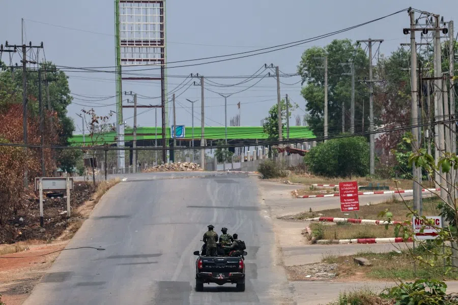 Soldiers from the Karen National Liberation Army (KNLA) patrol on a vehicle, next to an area destroyed by Myanmar’s airstrike in Myawaddy, the Thailand-Myanmar border town under the control of a coalition of rebel forces led by the Karen National Union, in Myanmar, on 15 April 2024. (Athit Perawongmetha/Reuters)