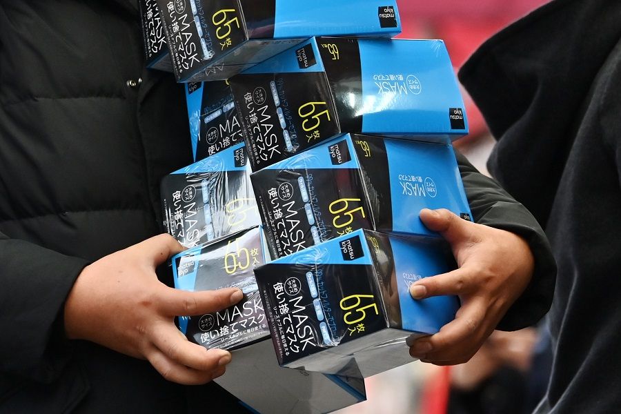 Japan sent masks to China when they were faced with the Covid-19 crisis, and now China is offering masks to Japan to reciprocate Japan's kindness. In this photo, a customer buys face masks from a drugstore in Tokyo's Akihabara area on 27 January 2020. (Charly Triballeau/AFP)