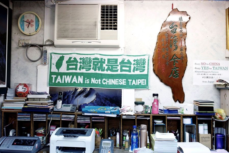 Taiwan pro-independence signs hang on the wall of a shop in Taipei, Taiwan, on 2 April 2020. (Ann Wang/Reuters)