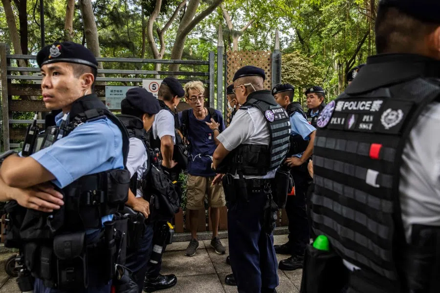 Police near a carnival at Victoria Park to celebrate the 26th anniversary of the city's handover from Britain to China, in Hong Kong, China, on 1 July 2023. (Isaac Lawrence/AFP)