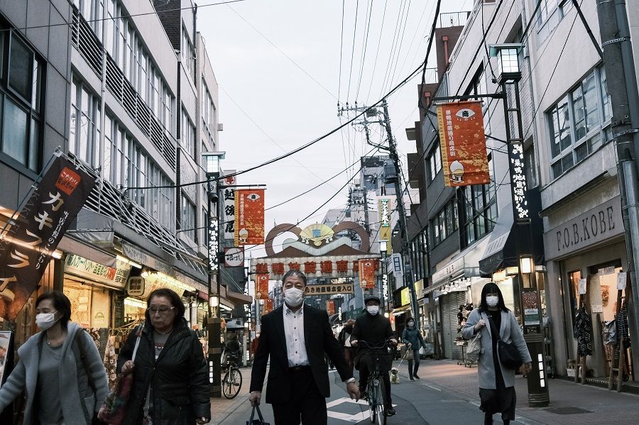 Pedestrians walk on the Sugamo Jizo-dori shopping street in the Toshima district of Tokyo, Japan, on 11 December 2020. (Soichiro Koriyama/Bloomberg)