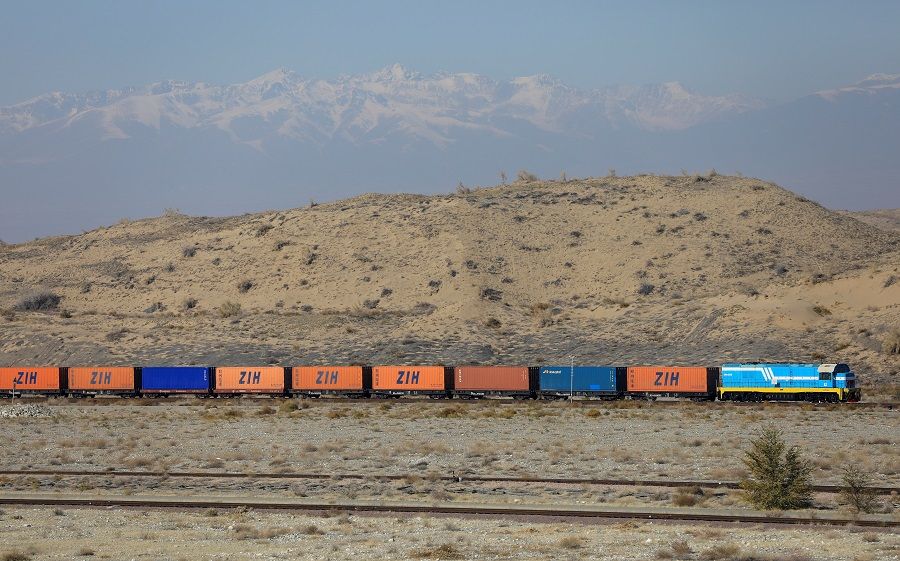 A train carrying shipping containers drives across at the Altynkol railway station near the Khorgos border crossing point on the border with China in Kazakhstan, 26 October 2021. (Pavel Mikheyev/Reuters)