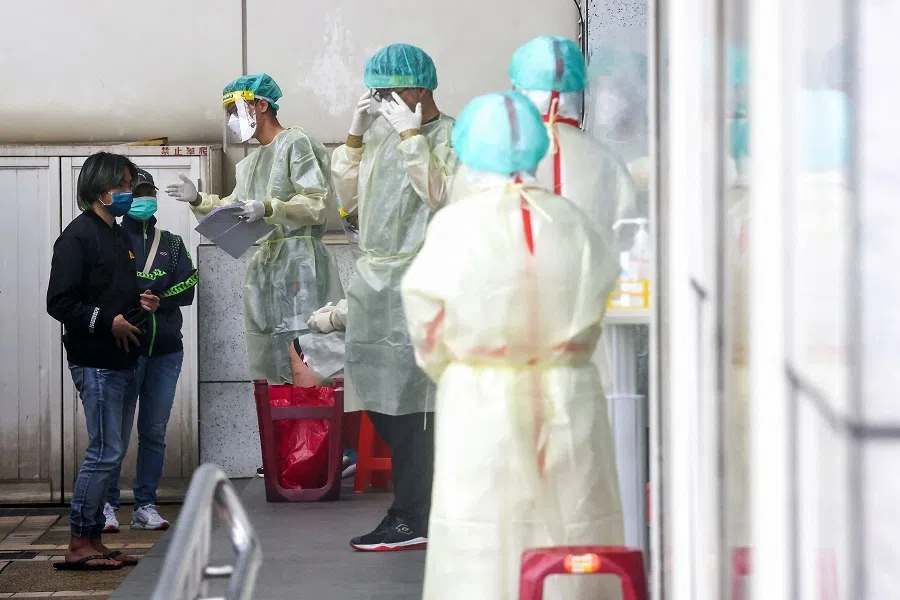 People wait to get a Covid-19 test in Taipei, Taiwan, 24 May 2022. (Ann Wang/Reuters)