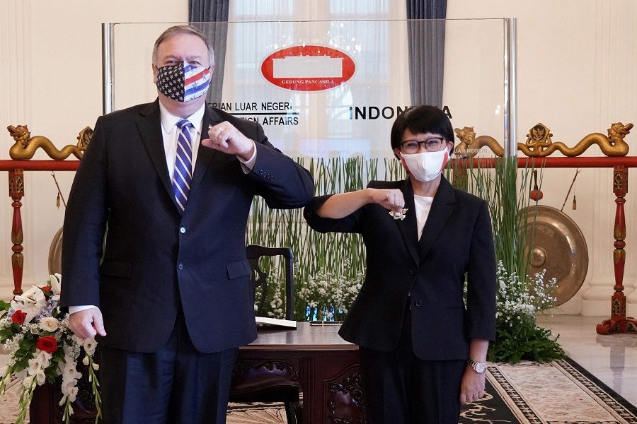 This handout photograph taken and released on 29 October 2020 by the Indonesian Foreign Ministry shows then-US Secretary of State Michael Pompeo (left) posing with Indonesian Foreign Minister Retno Marsudi during their meeting in Jakarta. (Handout/Indonesian Foreign Ministry/AFP)