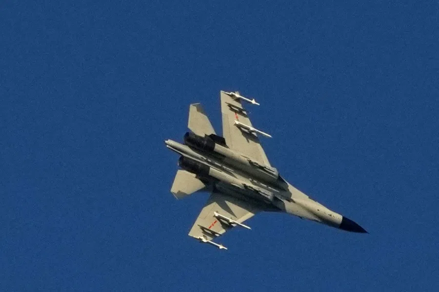 A Chinese People's Liberation Army (PLA) aircraft flies over the 68-nautical-mile scenic spot, one of mainland China's closest points to the island of Taiwan, in Pingtan island, Fujian province, China, 5 August 2022. (Aly Song/Reuters)