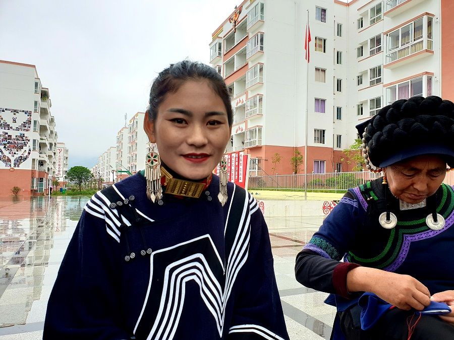 He Jianxiu (left) picked up embroidery after moving to the Community and even made it her livelihood.