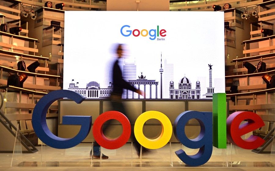 In this file photo taken on 22 January 2019 a technician passes by a logo of US internet search giant Google during the opening day of a new Berlin office of Google in Berlin. (Tobias Schwarz/AFP)