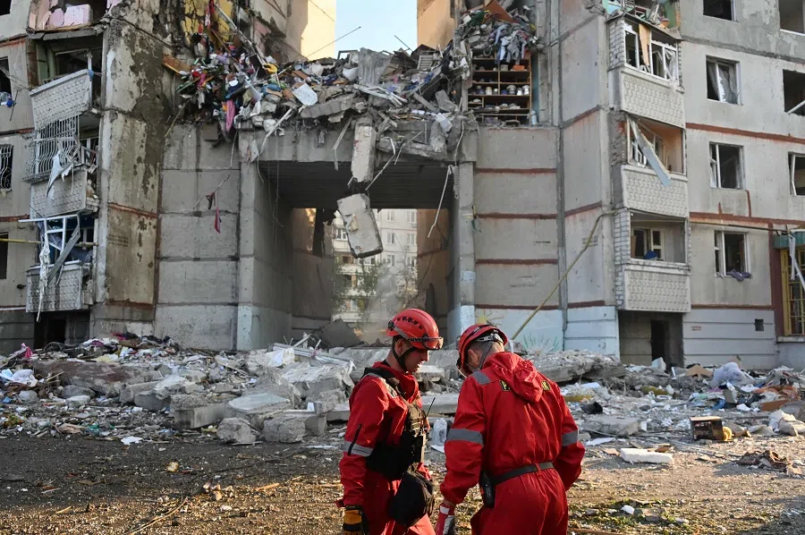 State Emergency Service of Ukraine rescuers stand next to an apartment building destroyed during an airstrike in Kharkiv, on 24 September 2024, amid the Russian invasion of Ukraine. (Sergey Bobok/AFP)