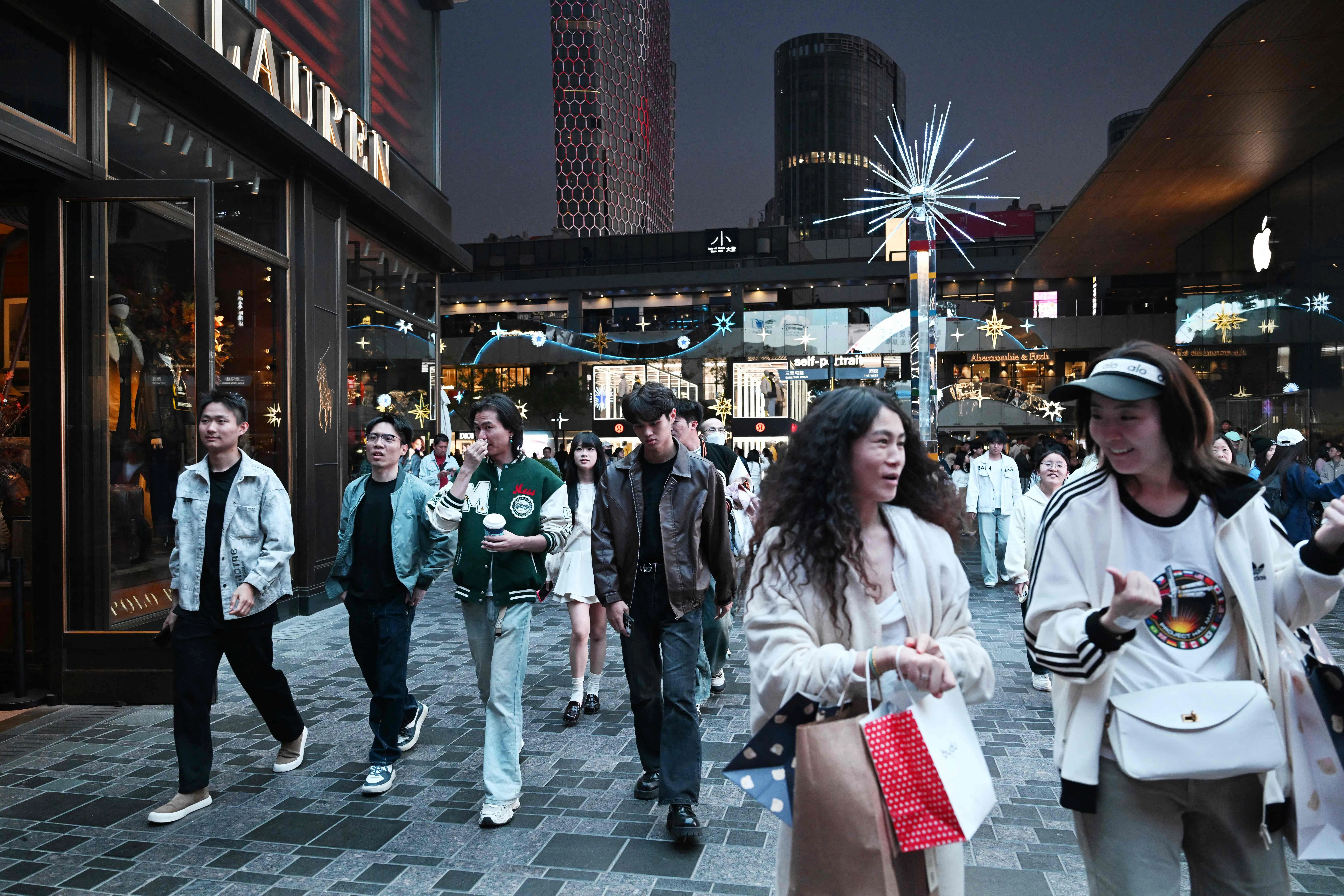 People walk through a shopping mall in Beijing on 7 October 2026.