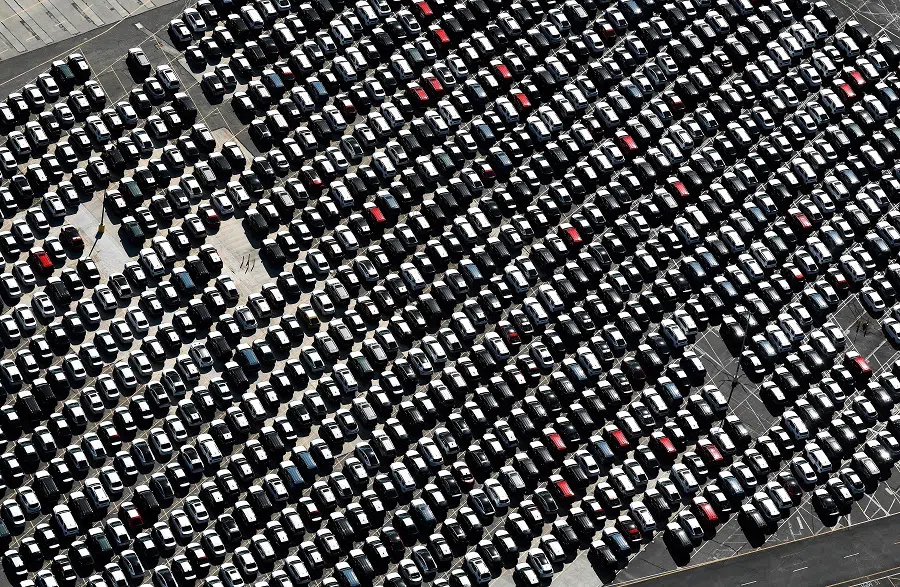 An aerial view of new imported cars parked at an automobile processing terminal located at the Port of Long Beach on 3 April 2024 in Long Beach, California. (Mario Tama/Getty Images via AFP)