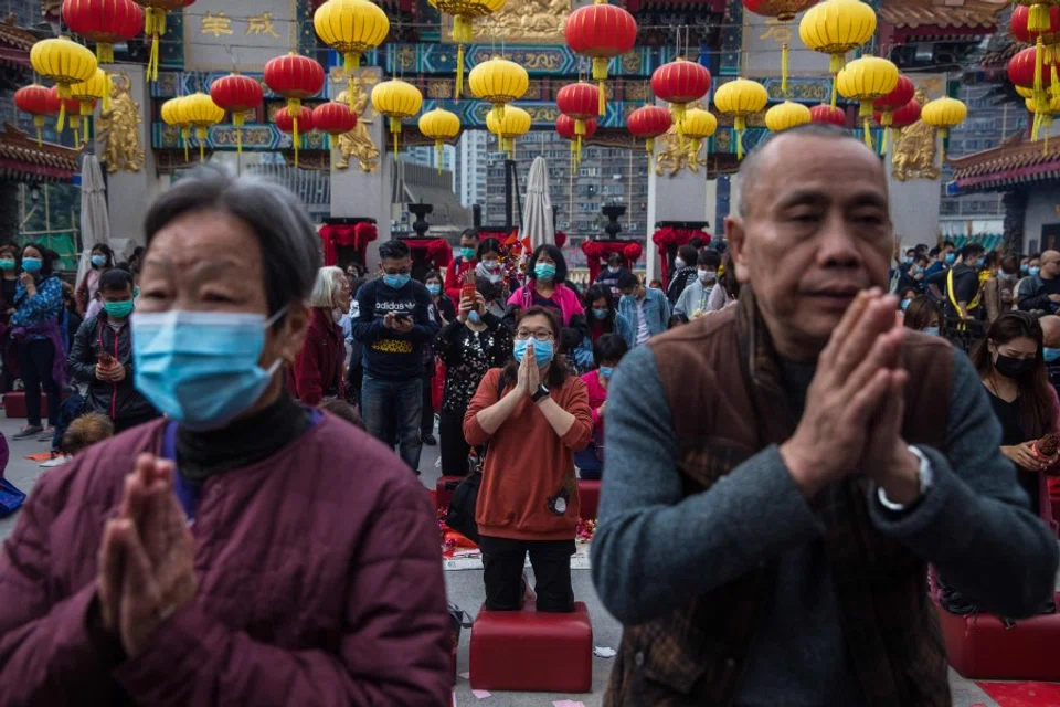 Visitors offer up prayers on the first day of the first lunar month at Wong Tai Sin temple in Hong Kong, 25 January 2020. (Dale de la Rey/AFP)