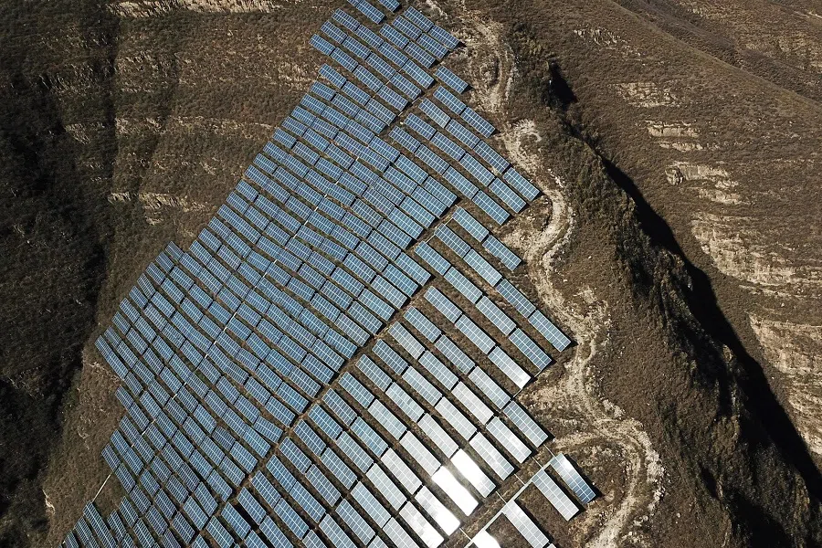 This photo taken on 22 October 2021 shows solar panels on hillsides at Qu village in Baoding, Hebei province, China. (Greg Baker/AFP)