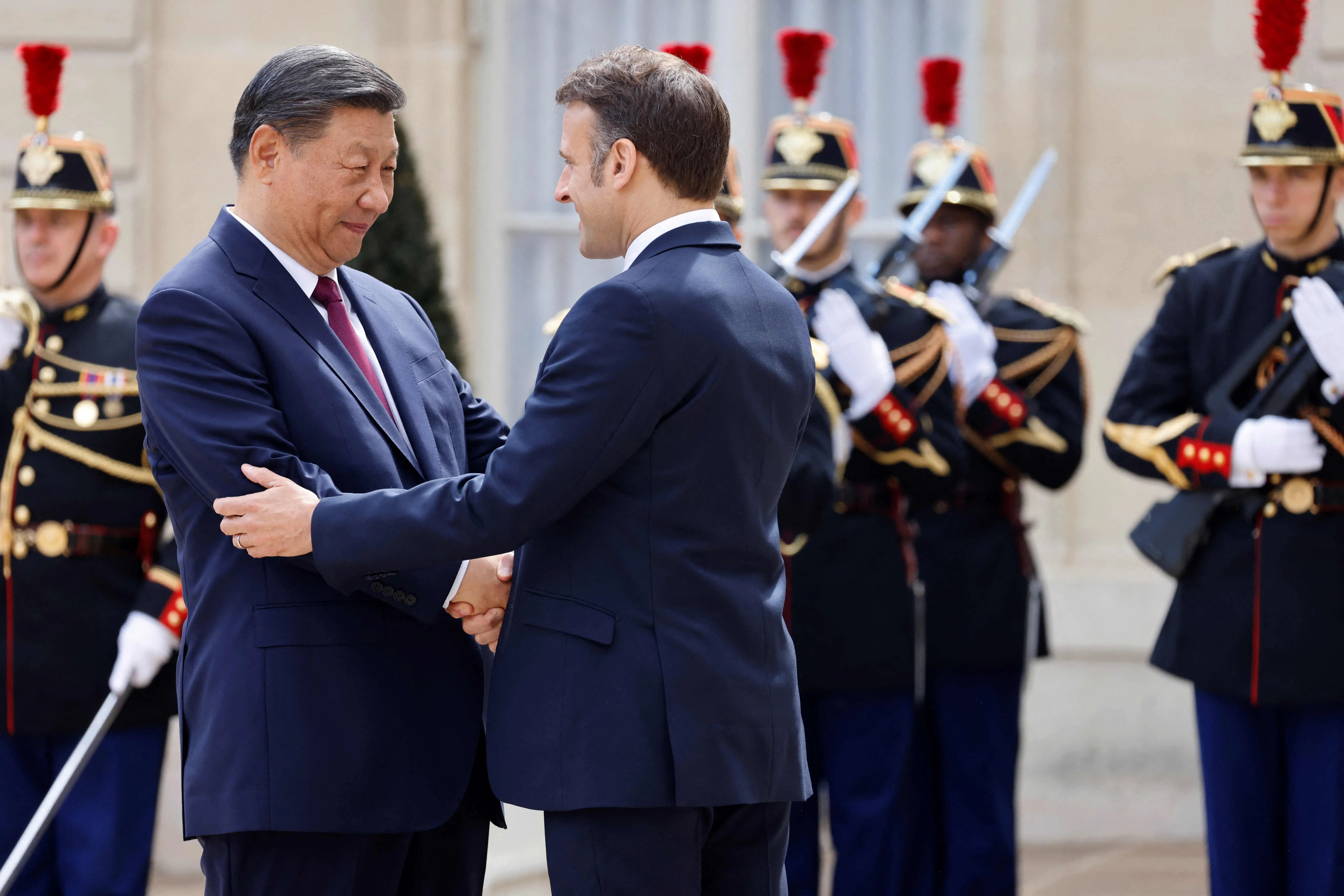 France’s President Emmanuel Macron (right) greets Chinese President Xi Jinping at The Elysee Presidential Palace in Paris on 6 May 2024. (Ludovic Marin/AFP)