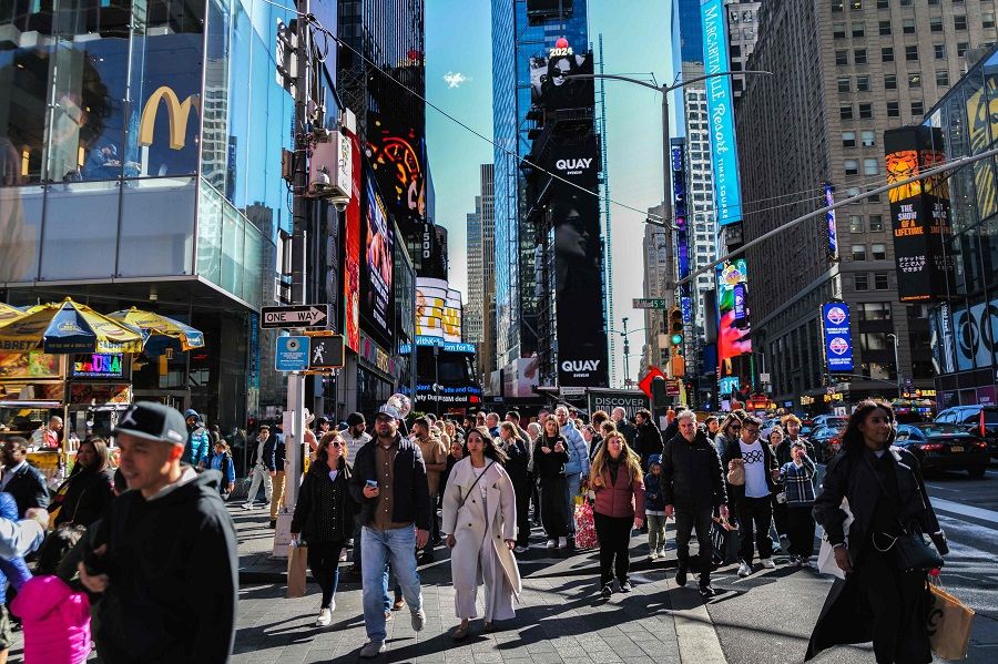 Visitors and tourists making their way through Times Square in New York City on 7 April 2024. (Charly Triballeau/AFP)