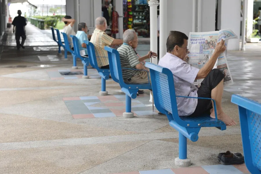 Reading for leisure at the foot of a block in Chin Swee estate. (SPH Media)