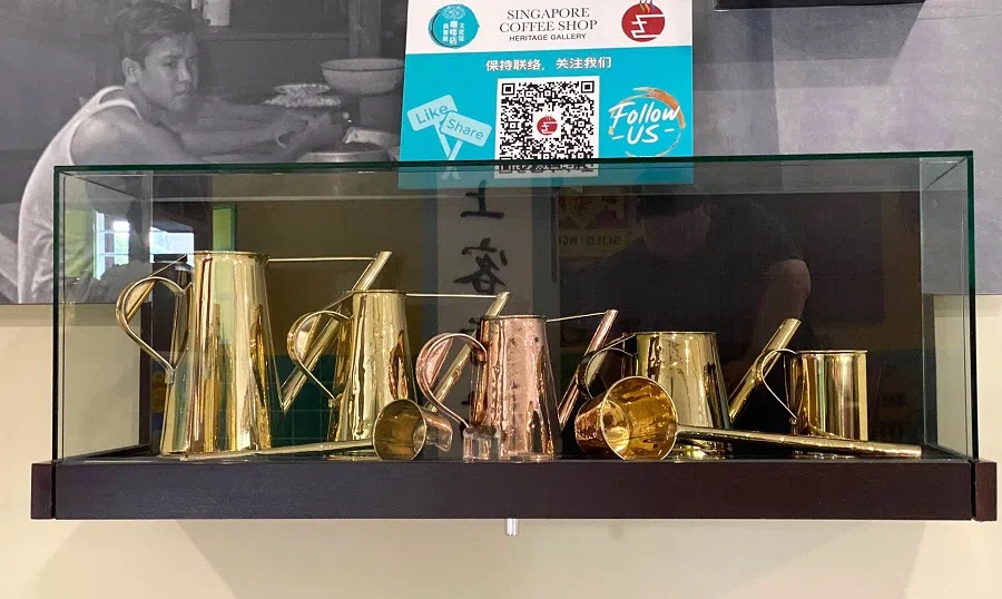 A glistening set of old copper coffee pots symbolises the fact that today, holding a coffee pot is like holding a golden rice bowl. (Photo provided by the Singapore Coffee Shop Heritage Gallery)