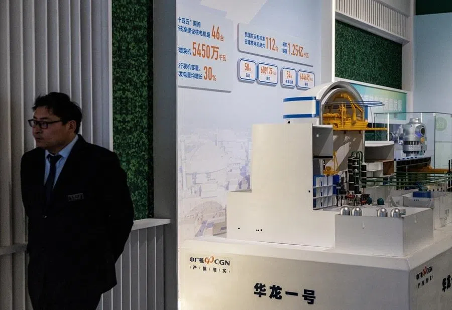 A member of security personnel looks on next to the display of Hualong One nuclear reactor, under the China General Nuclear Power Group, at an exhibition on China’s manufacturing achievements at the National Museum in Beijing, China, 24 March 2026.