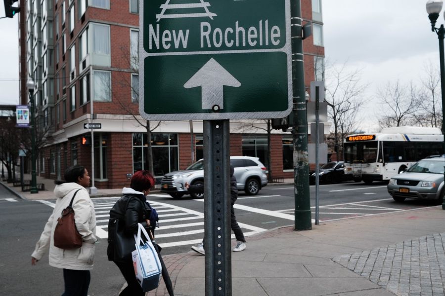 Should Western countries adopt the lockdown policy? In this photo taken on 10 March 2020, people walk through downtown in New Rochelle, New York. (Spencer Platt/Getty Images/AFP)