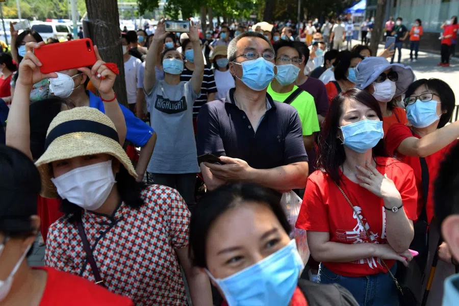 Parents wait for their children to emerge from a school after taking the gaokao, 7 July 2020. (Greg Baker/AFP)