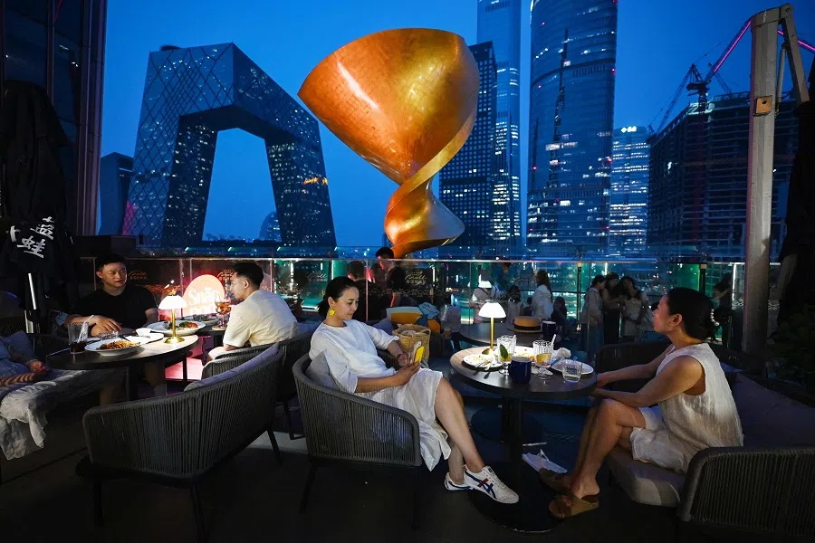 People eat in a restaurant in Beijing’s central business district on 11 July 2024.  (Greg Baker/AFP)