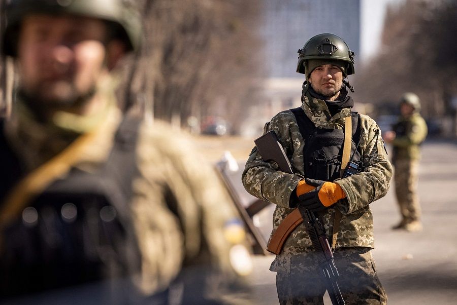 Ukrainian servicemen stand guard at a military checkpoint in Kyiv, Ukraine, on 21 March 2022. (Fadel Senna/AFP)