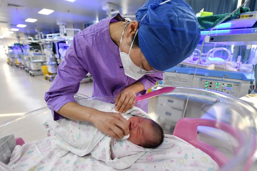 A nurse takes care of a newborn baby at a hospital in Fuyang, in China's eastern Anhui province on 17 January 2023. (AFP)