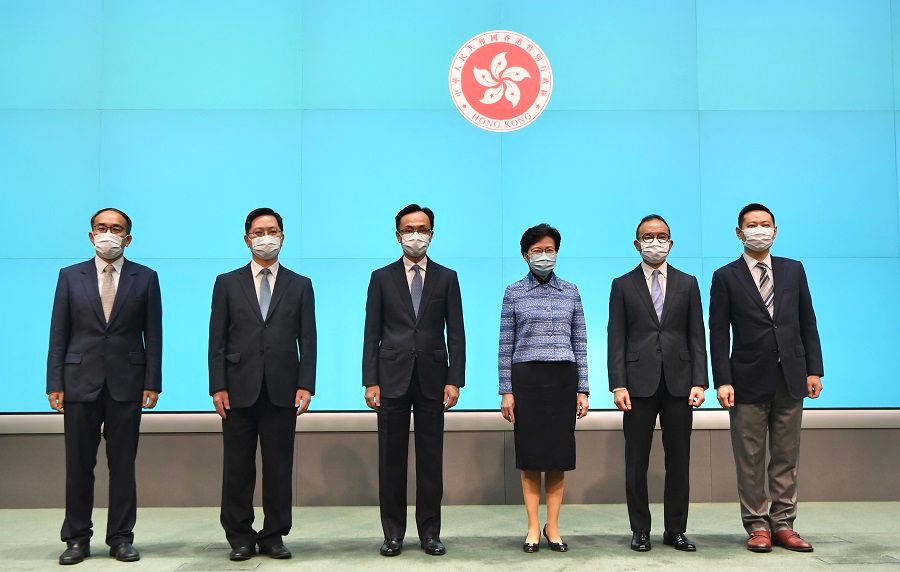 Chief Executive Carrie Lam (third from right) and the newly appointed officials following the major political reshuffle at a press conference held on 22 April 2020: Christopher Hui Ching-yu (first from left), Alfred Sit Wing-hang (second from left), Patrick Nip Tak-kuen (third from left), Erick Tsang Kwok-wai (second from right), and Caspar Tsui Ying-wai (first from right). (HKCNA/CNS)